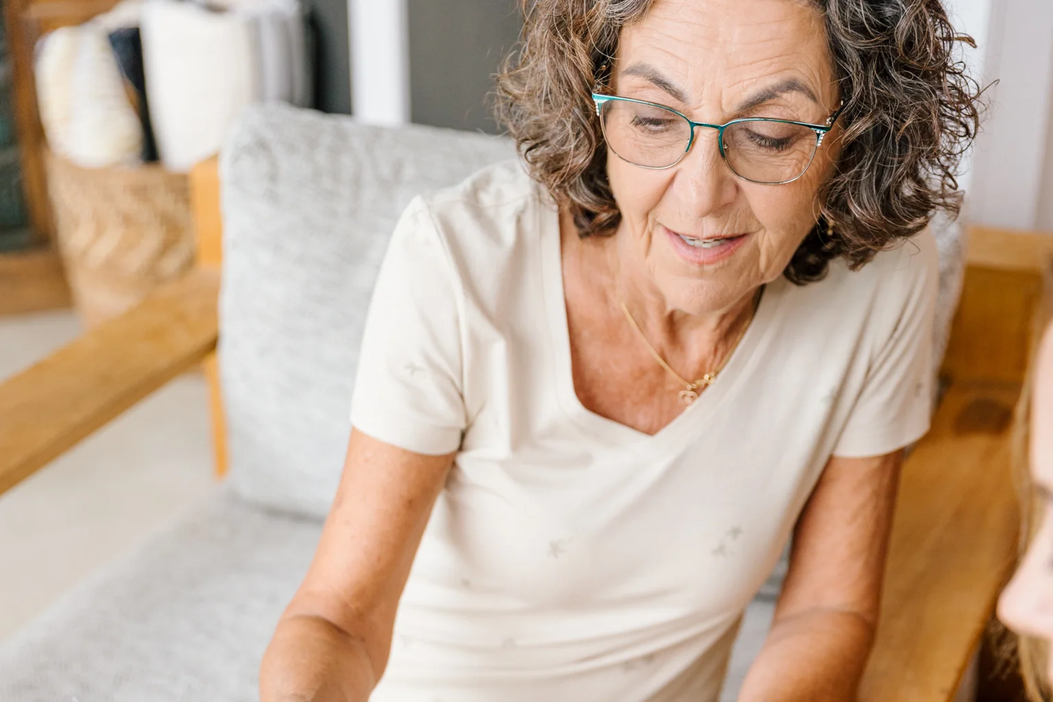 Older woman reading through her written care plan during a Prata Health nursing visit at home