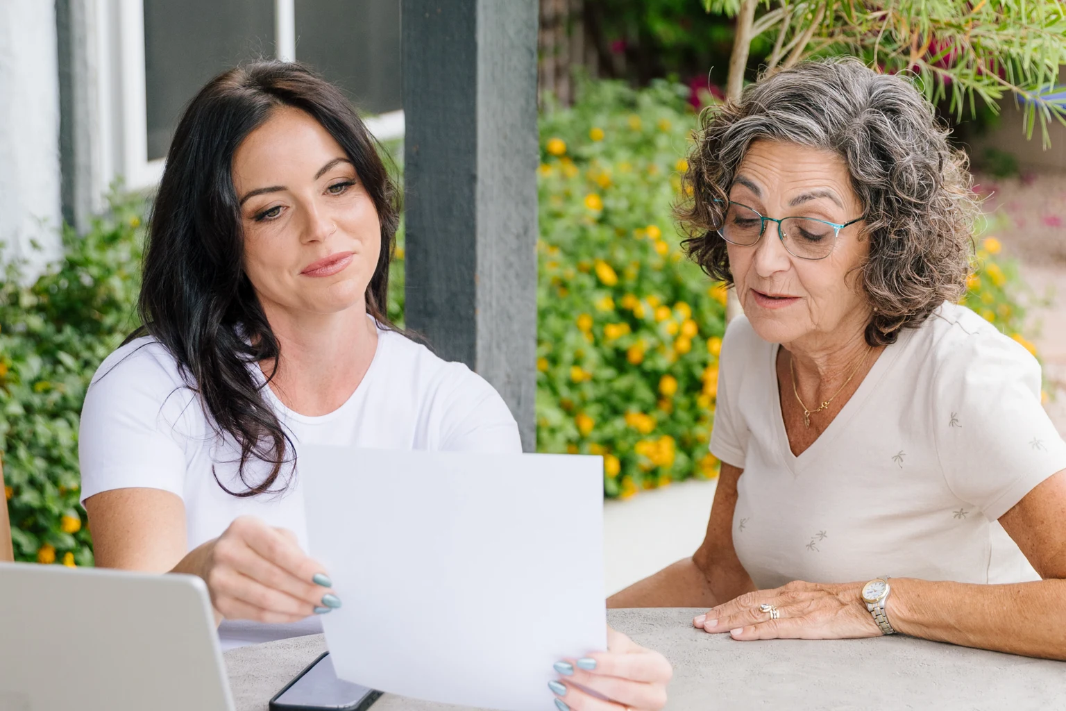 Prata Health registered nurse reviewing a written care plan with a client at her home in Arizona