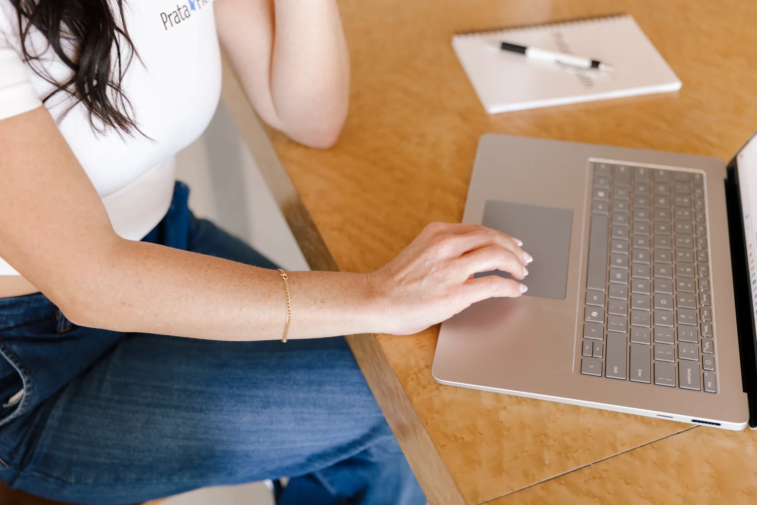Registered nurse coordinating a client's records and appointments on a laptop