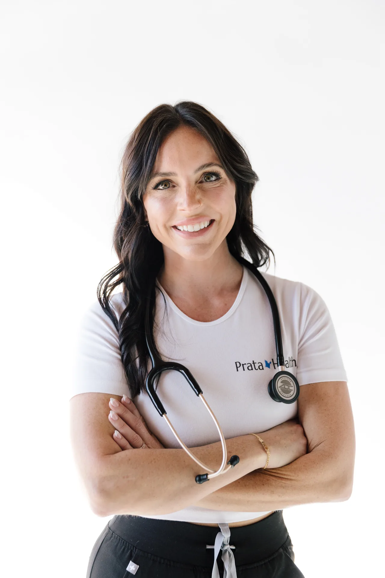Founder Bianca Fabbo, RN, in a Prata Health shirt with a stethoscope around her neck